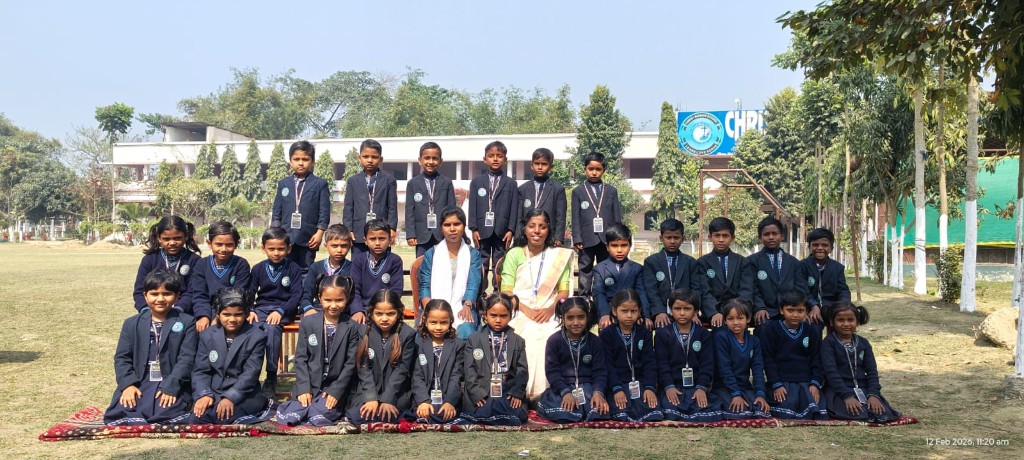 Primary kids and instructors posing on CMS campus lawns