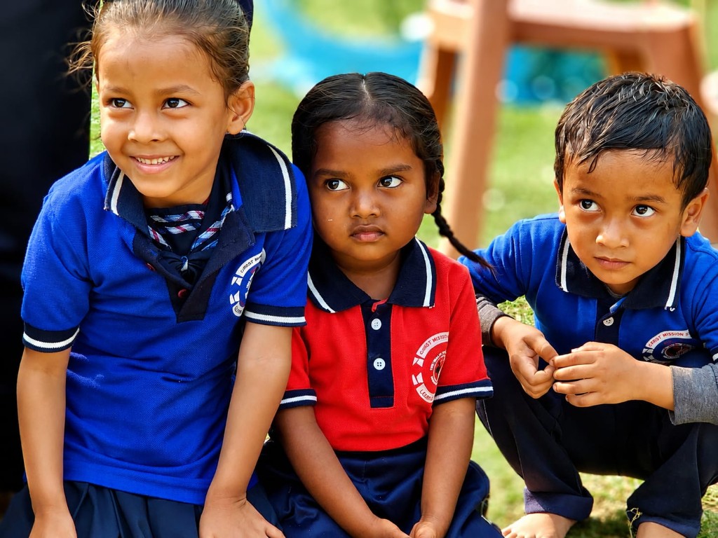 Young students in Christ Mission School uniforms at a sports event