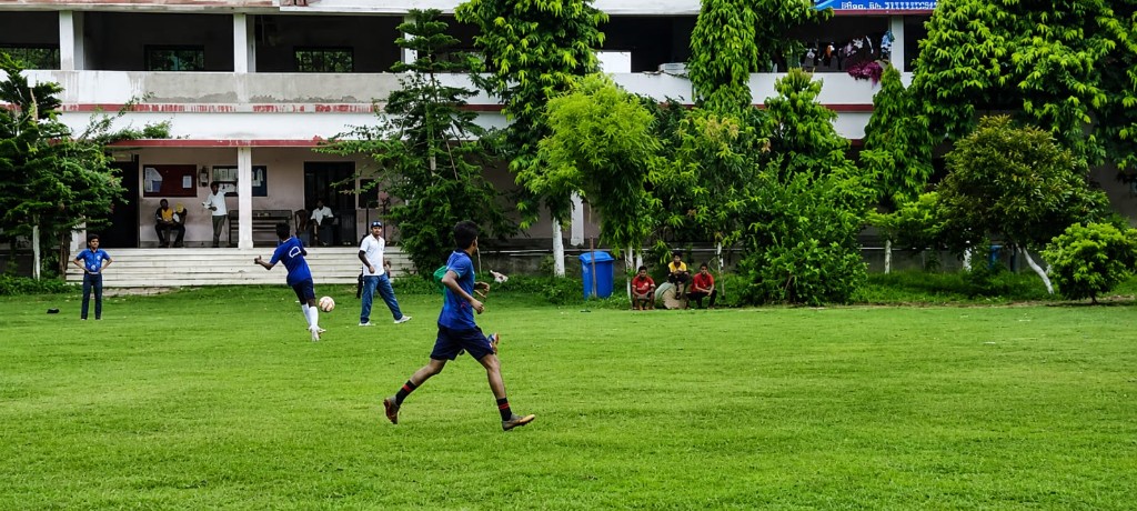 Students playing football on the field during the Sports Meet opening at Christ Mission School