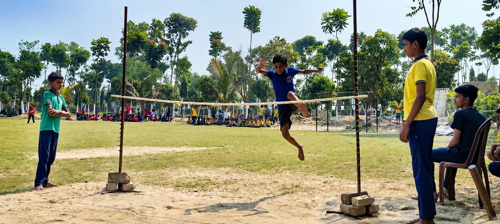 Student clearing the high jump bar during Sports Meet inauguration at Christ Mission School